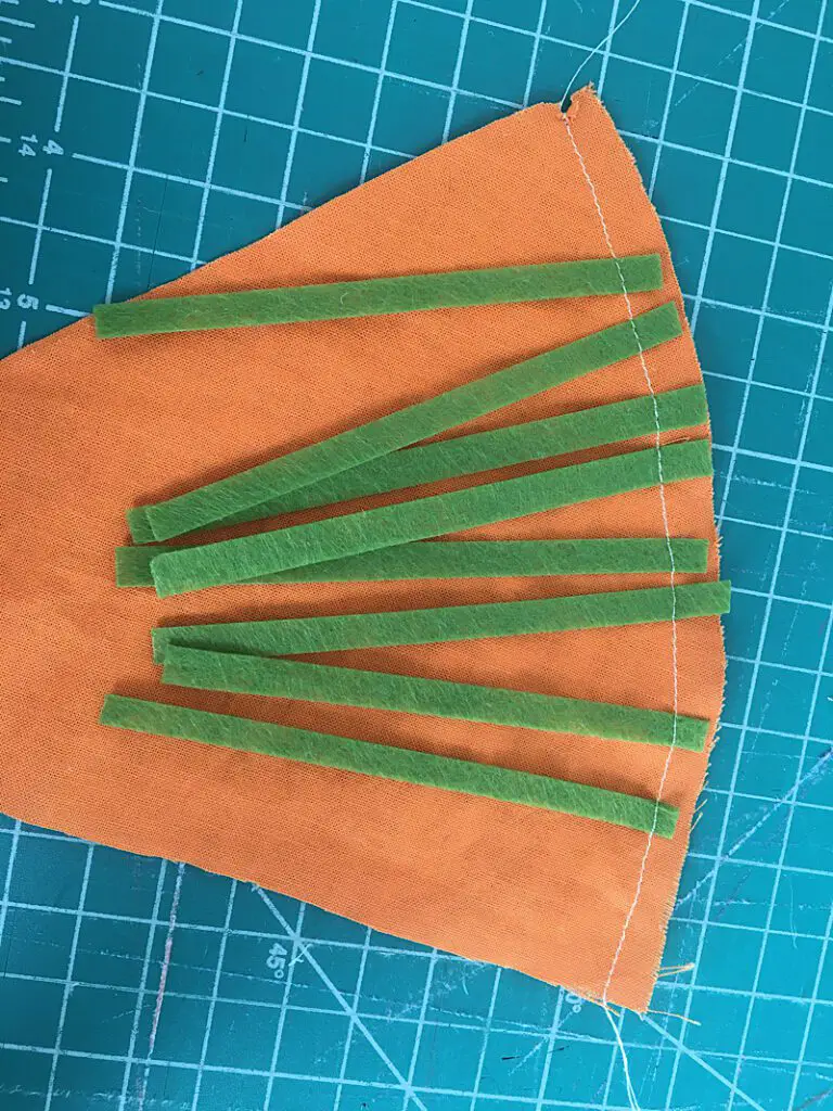 sewing the strips to the carrot fabric