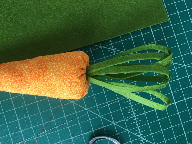 putting leaves on the carrot