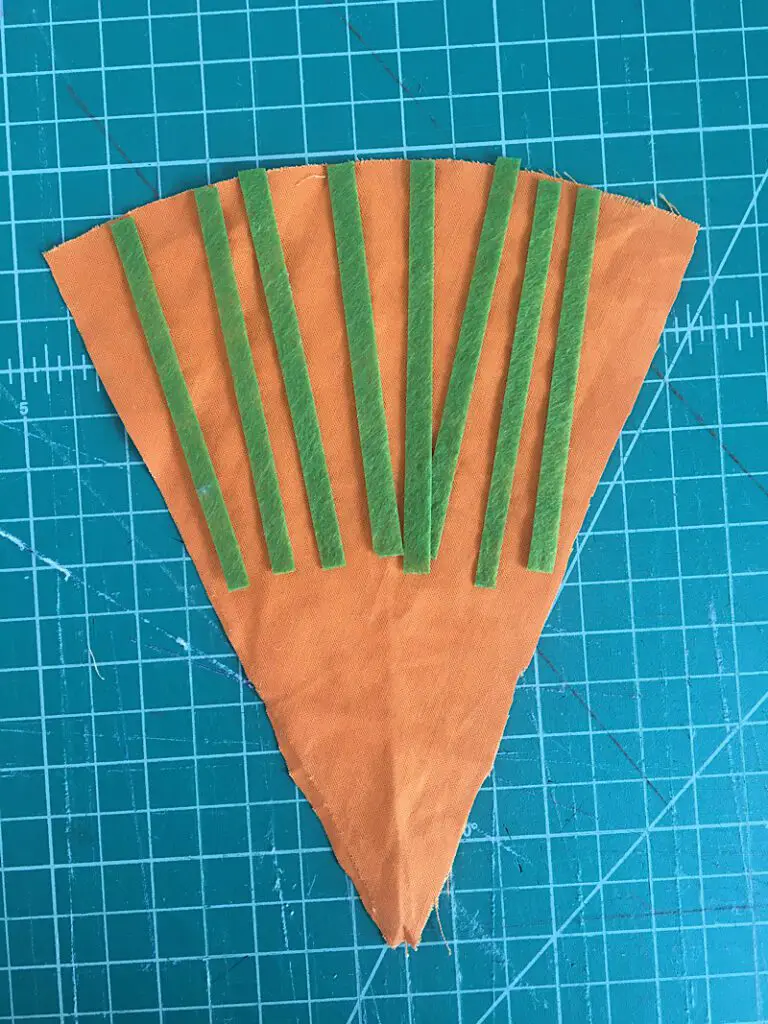 laying strips of felt on carrot
