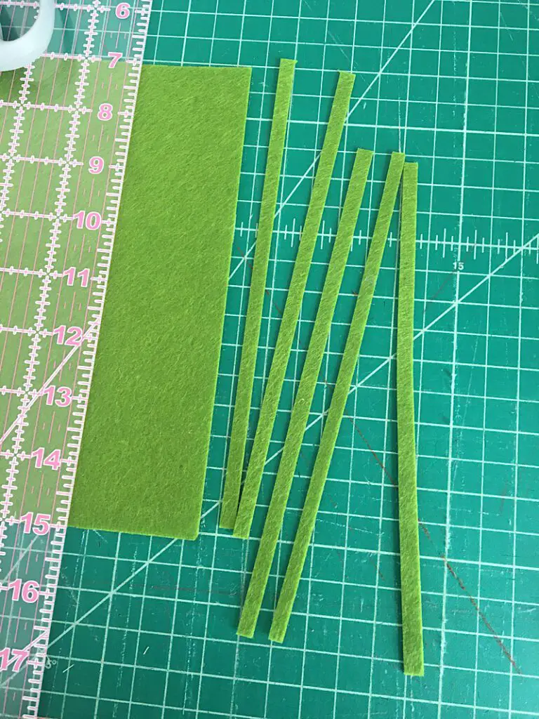 Cutting out long strips of felt for the carrot leaves