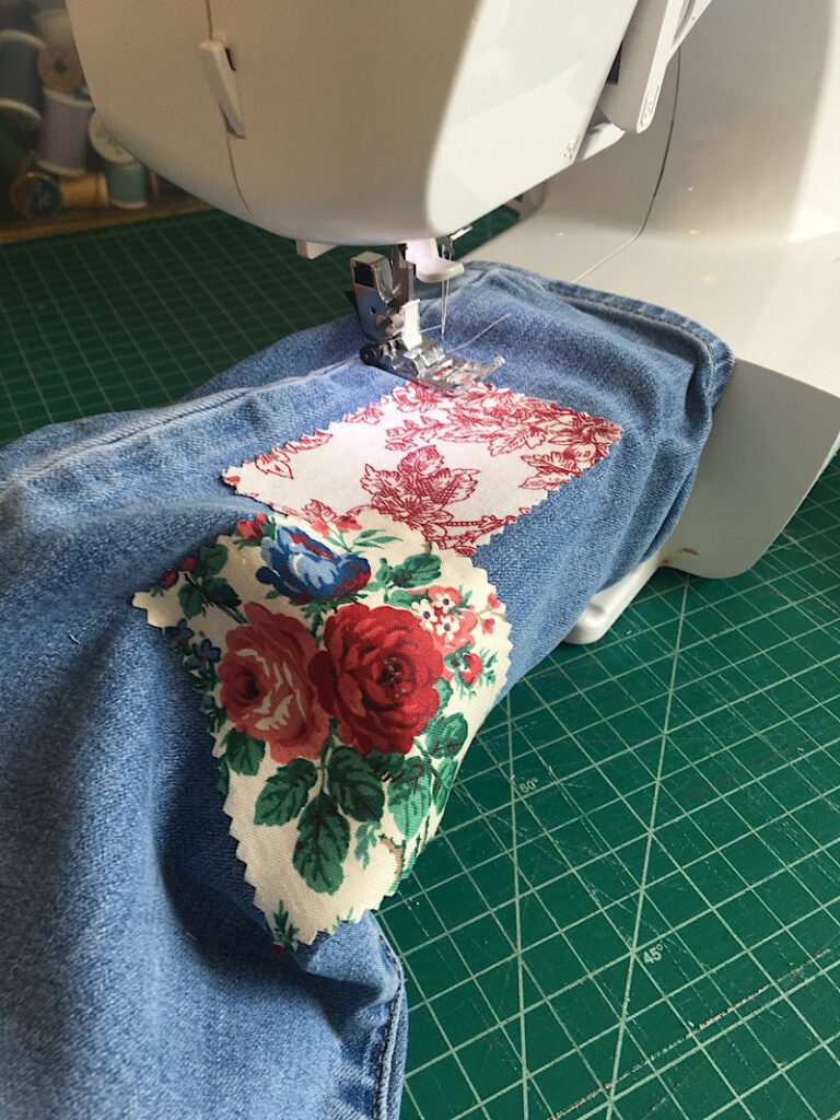 sewing patches onto jeans with a sewing machine