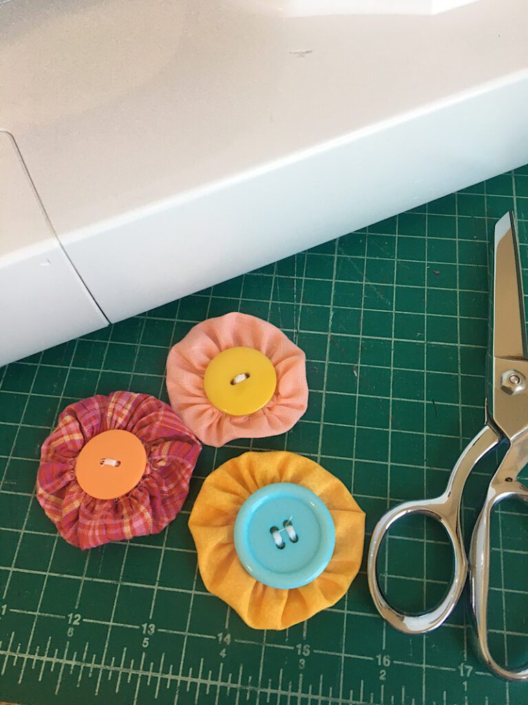 buttons sewn to fabric yoyo flowers