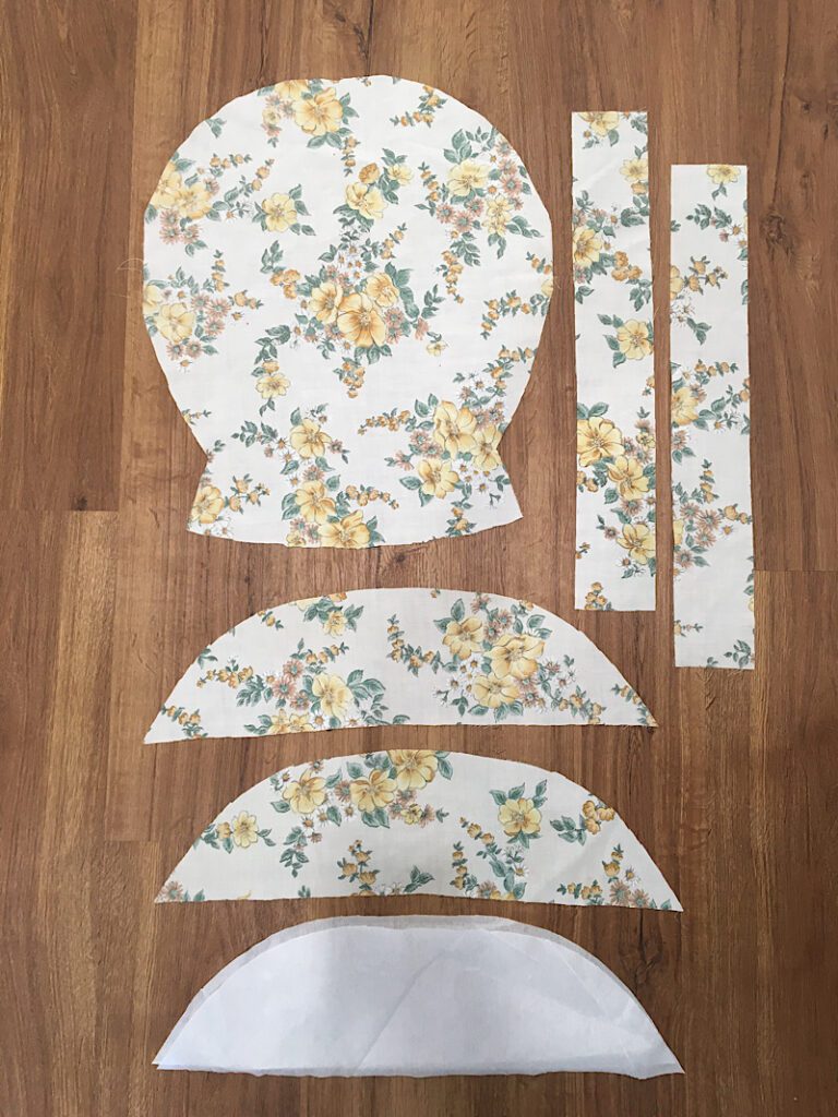 bonnet sewing fabric pattern pieces laid on floor