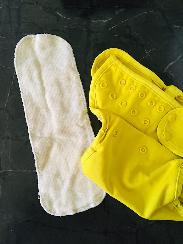DIY cloth diaper insert with a yellow cover