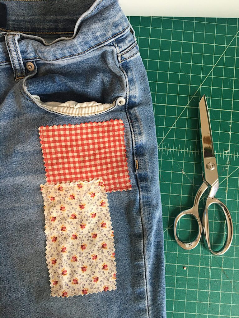 sewing patches onto pockets of pants