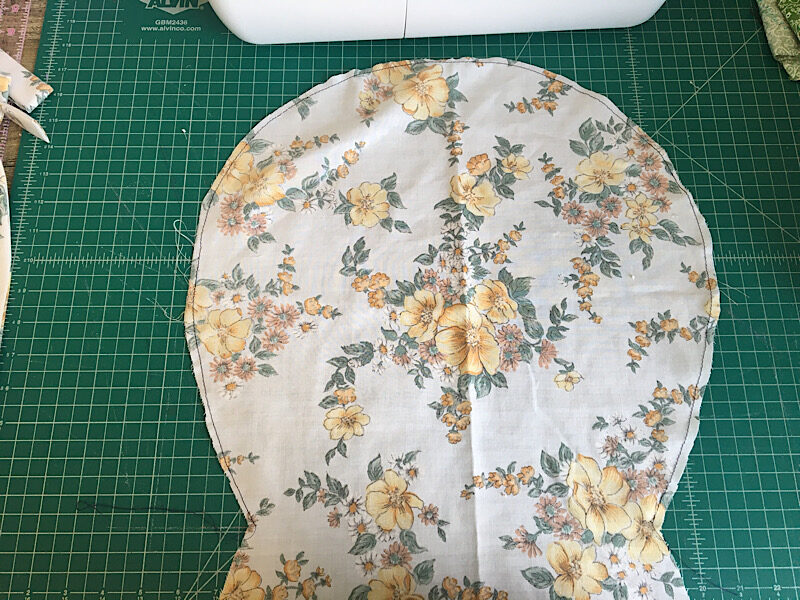 sewing a basting stitch around the bonnet cap
