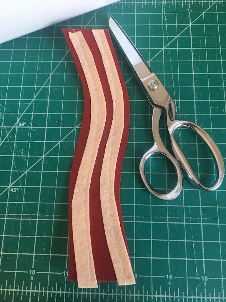 sewing the fat to the felt bacon