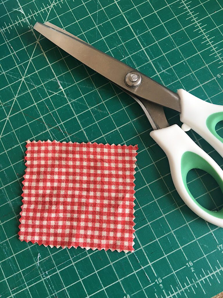 cutting out a patch of scrap fabric