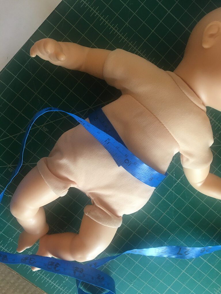 measuring the dolls waist to make pants