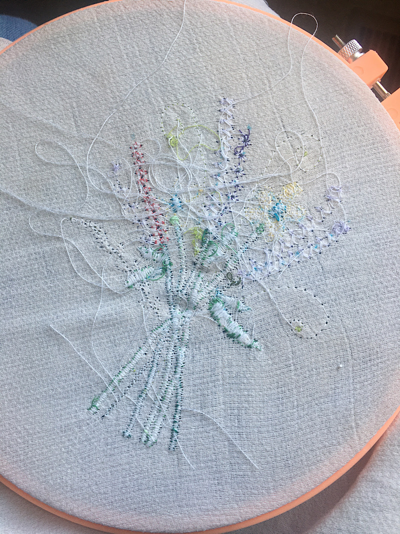 trimming the threads off the back of messy embroidery