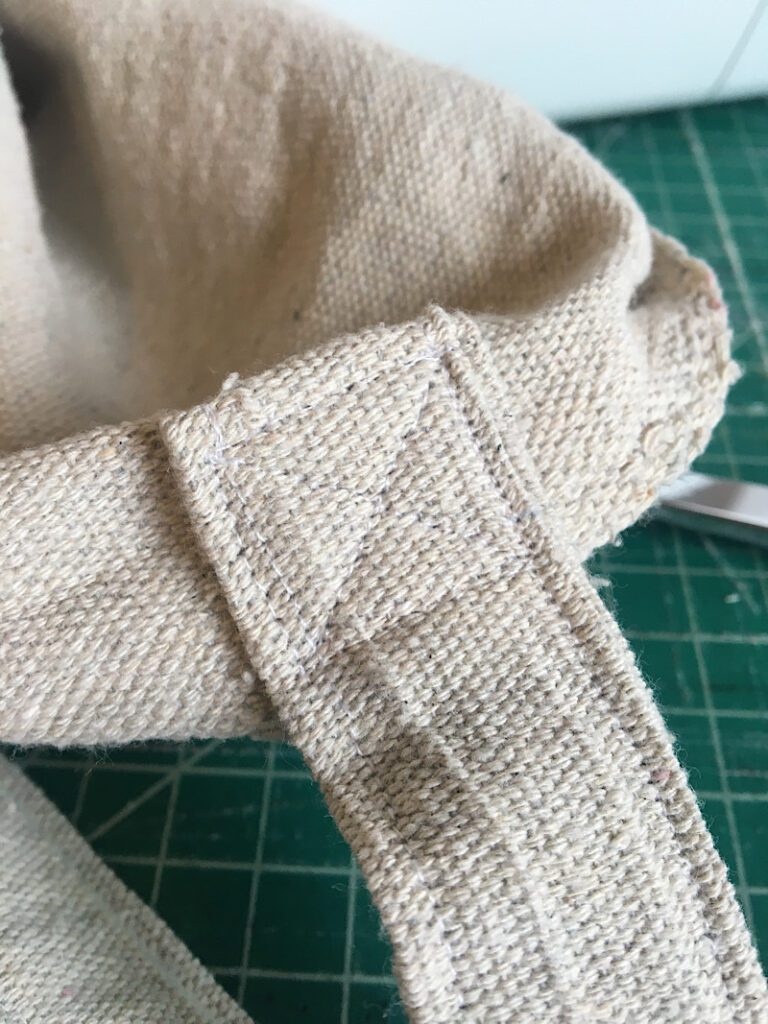 sewing the handle in place on the tote bag diy drop cloth