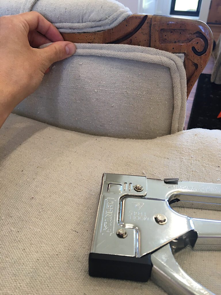 applying the double piping to the chair and a staple gun