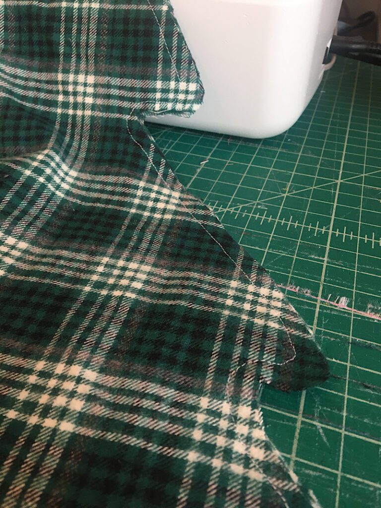 sewing around the edge of christmas tree pillow