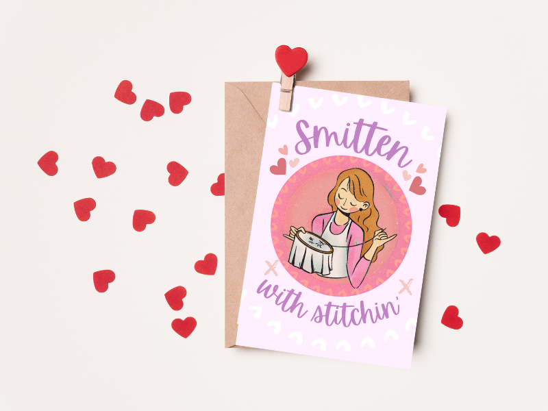 valentines card with embroidering girl, text reads smitten with stitchin