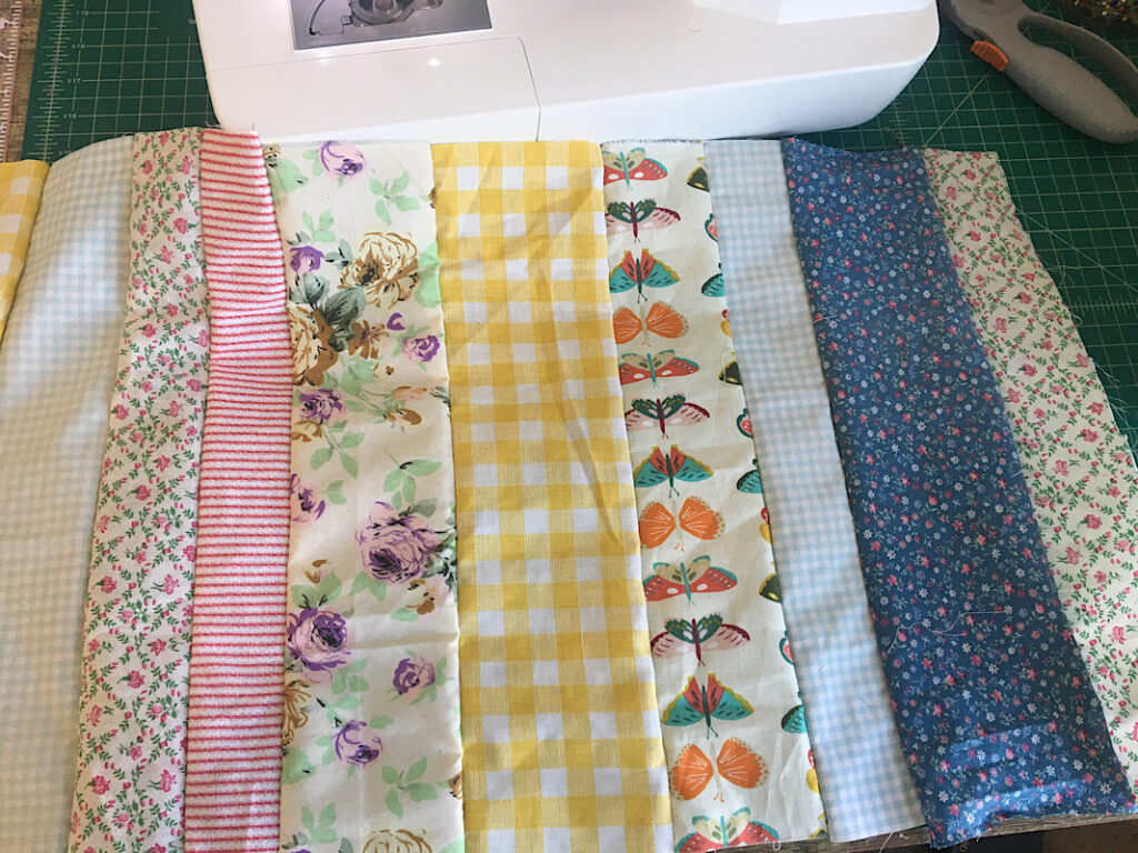 sewing fabric strips together into a laptop case
