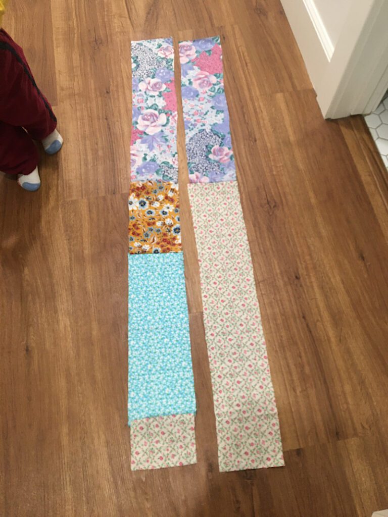 two strips of fabric on floor