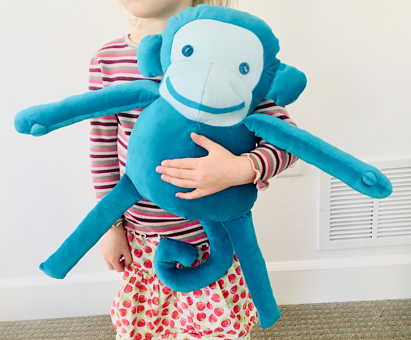 Girl holding a stuffed monkey