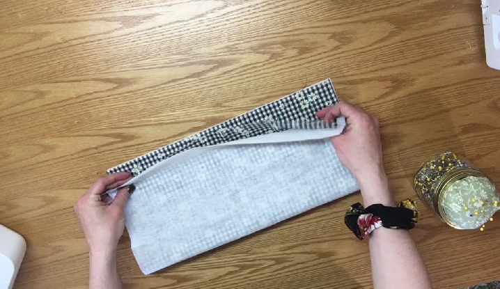folding stabilizer and fabric together in half