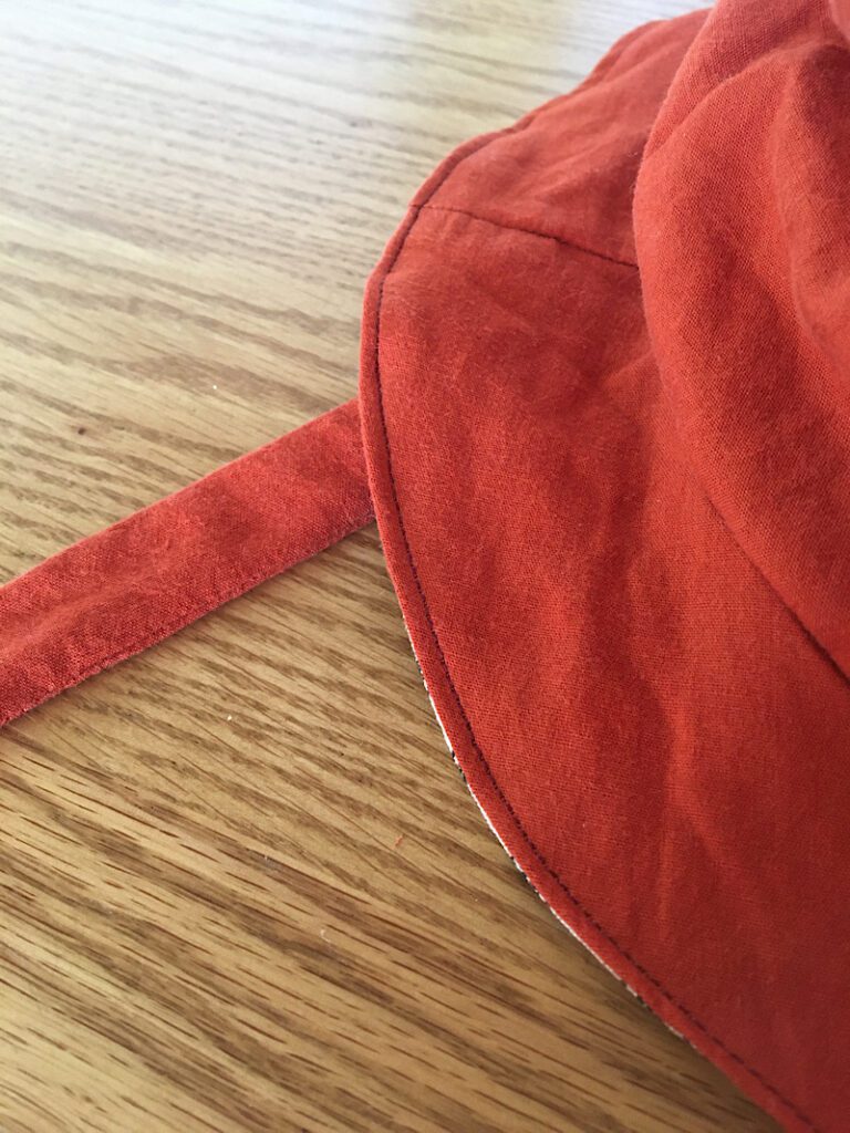 Sewing the brim of the sun hat