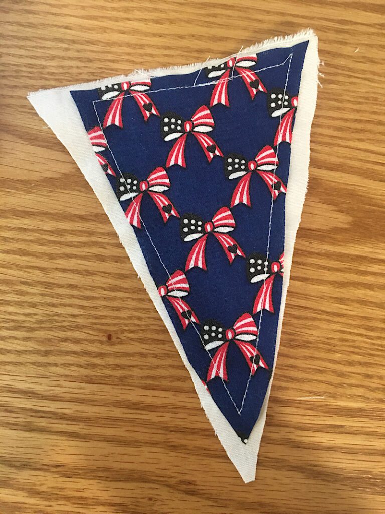 Blue triangle sewn to white triangle