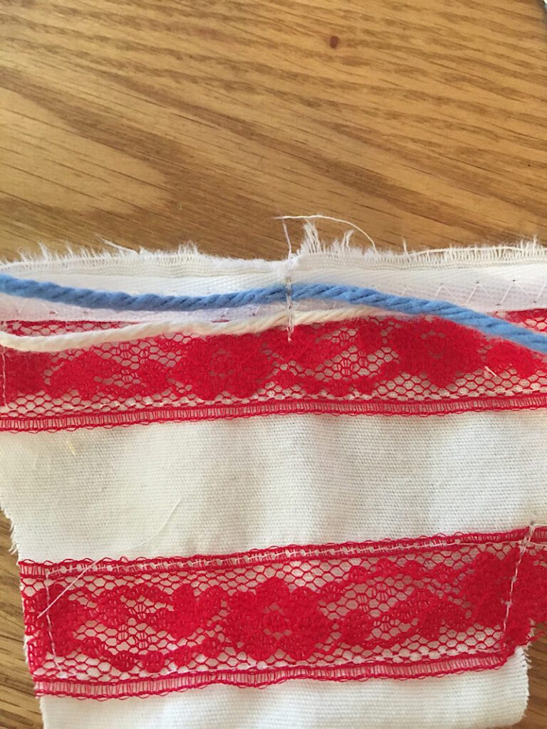 sew strings to top of triangle pennant