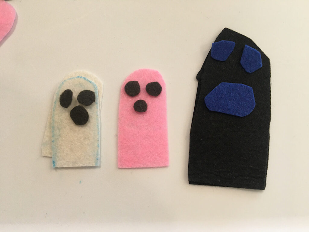 three ghost finger puppets