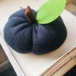 A stuffed pumpkin made from a beanie hat