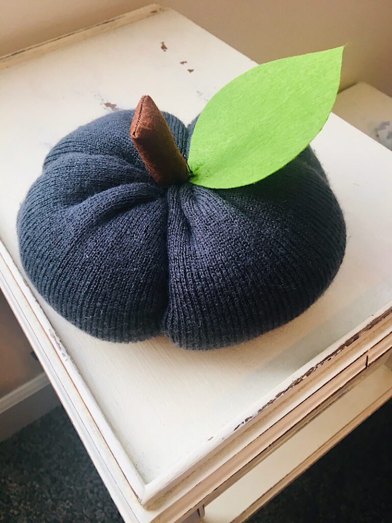 A stuffed pumpkin made from a beanie hat