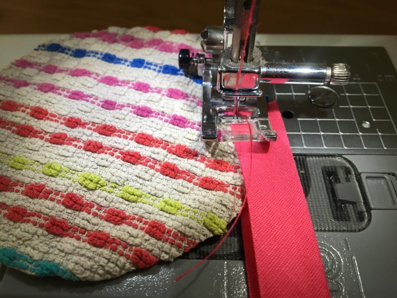 sewing the binding onto the towel coaster