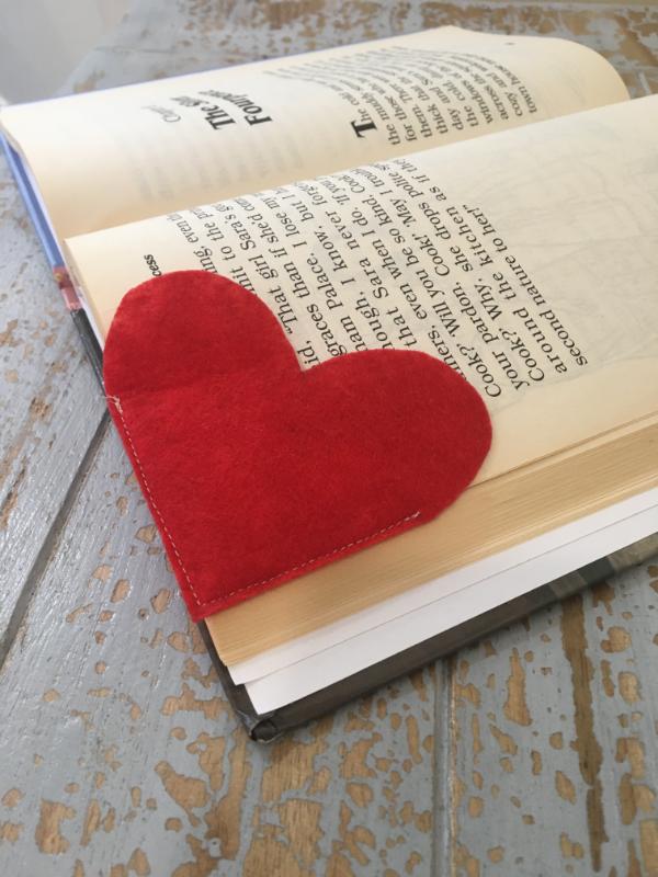 Heart shaped corner bookmark made of felt on a book